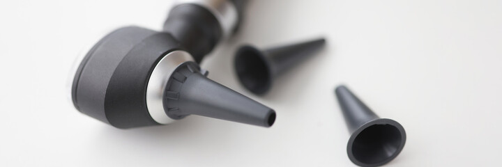 Closeup of otorhinolaryngologist otoscope tool on white background