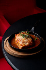 Side view ground beef lasagna with tomato sauce