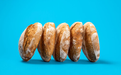 Homemade sourdough bread loaves on a blue background.