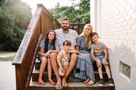 Family Sitting On Porch Steps Together