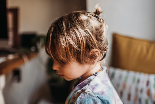 Young boy with pony tale hairstyle at home