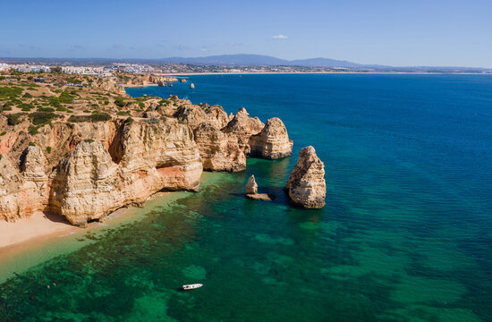 aerial landscape of blue sea and limestone cliffs on Algarve coast