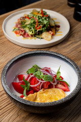 Summer breakfast with omelette and tomato salad with red onion, side view