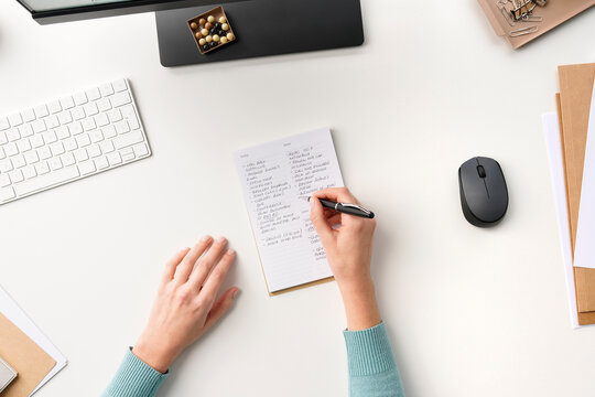 Crop worker making notes in planner