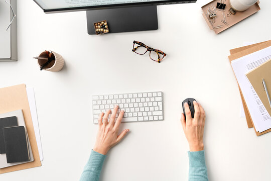 Anonymous employee browsing computer on table