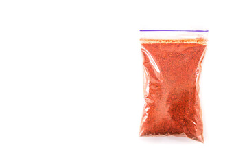 ground paprika in a plastic bag isolated on white background.