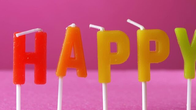 Happy in colorful letters on pink background