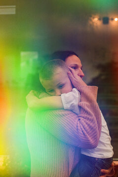 Mother tenderly hugging young son