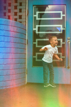 Happy boy dancing in front of door