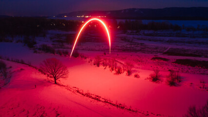 long exposure of a red firework at night