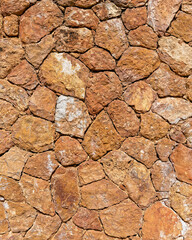 rough irregular cut brown stone wall, seamless pattern textured background