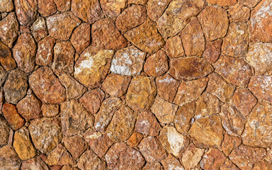 rough irregular cut brown stone wall, seamless pattern textured background
