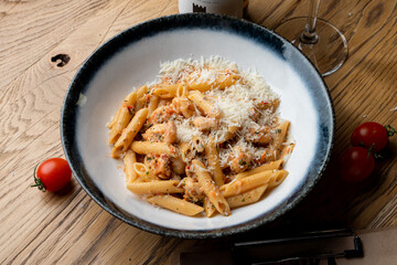 Ground beef pasta with a big pile of grated parmesan, rustic italian restaurant, vintage atmosphere