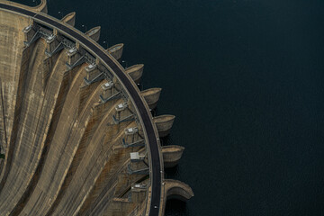 Aerial top view of an artificial dam and reservoir water