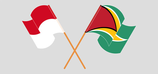 Crossed and waving flags of Monaco and Guyana