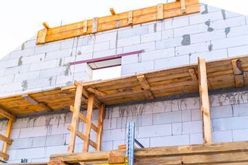 Scaffolding installed at a construction site. Building a house from white cinder block