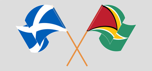 Crossed and waving flags of Scotland and Guyana