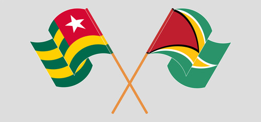 Crossed and waving flags of Togo and Guyana