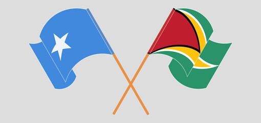 Crossed and waving flags of Somalia and Guyana