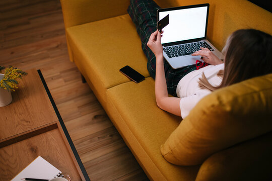 Woman Shopping Online On Sofa