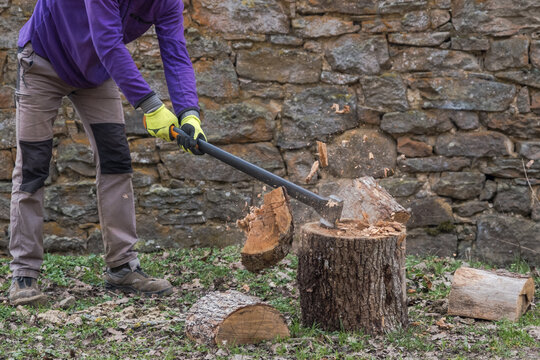 anonymous man splitting wood