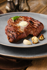 Closeup view of beef steak with a piece of butter