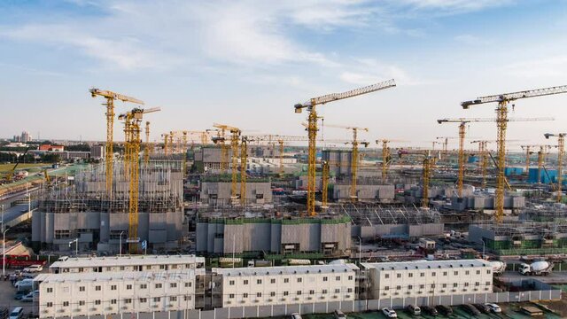 Aerial Flight Over a New Constructions Development Site with High Tower Cranes Building Real Estate. Heavy Machinery and Construction Workers are Employed. Xiongan new area of Beijing china.
