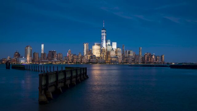 New York City Financial District skyscrapers and Hudson River. Timelapse from dusk to twilight. Lower Manhattan