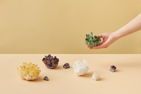 Woman holding green mineral ore crystal