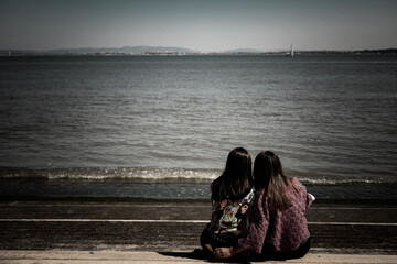 Friends near the Tagus river, in Lisbon