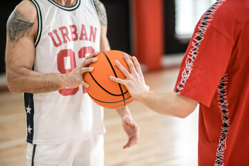 Two men in sportswear with a ball before the game