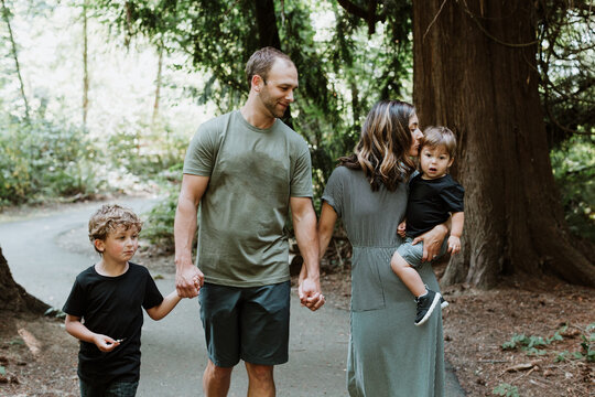 Happy Family Walking on Forest Trail