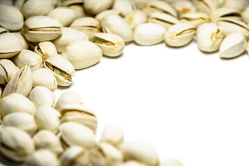 Close-up pile of beans it has a white nut shell dry and hard of Pistachio, Pistache or Pistacia vera on table food delicious salty snack copy space for white background
