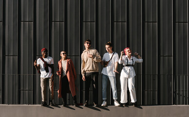 Diverse young friends dancing on street