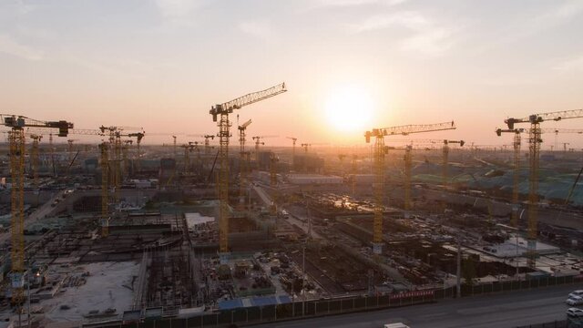 Aerial Flight Over a New Constructions Development Site with High Tower Cranes Building Real Estate. Heavy Machinery and Construction Workers are Employed. Xiongan new area of Beijing china.