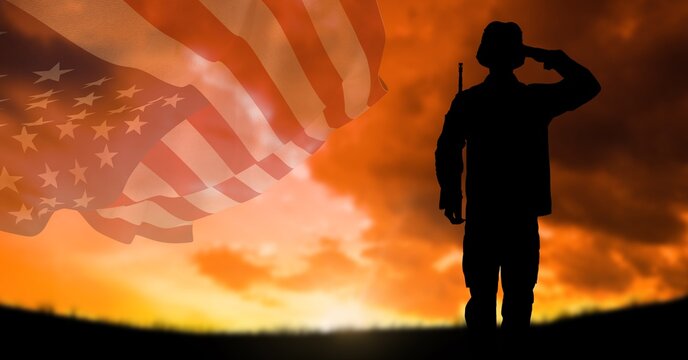 Composition of silhouette of saluting soldier against sunset sky with billowing american flag