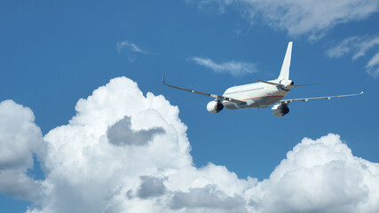 Zoom photo of passenger plane flying above deep blue cloudy sky