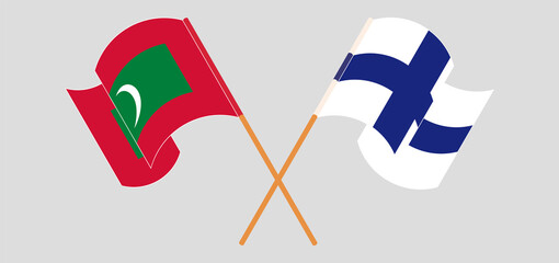 Crossed and waving flags of Maldives and Finland