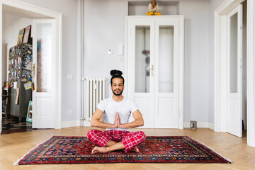 Man doing yoga at home
