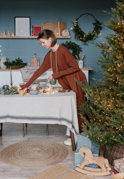 Woman decorating table on Christmas eve