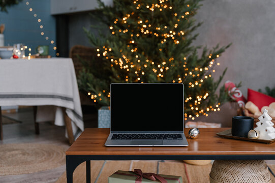 Laptop on table with Christmas gifts