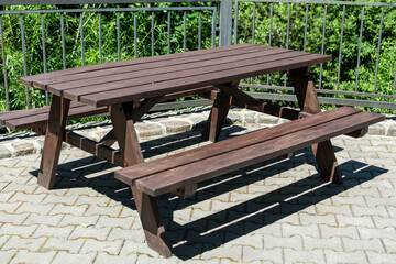 two wooden tables on a playground area