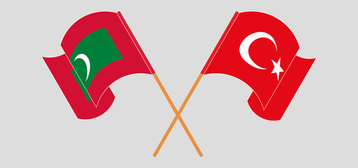 Crossed and waving flags of Maldives and Turkey