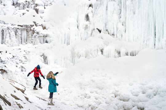 Boy and Girl Exploring Tiffany Falls Hamilton Frozen Waterfall in Winter