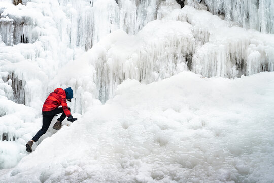 Boy Exploring Tiffany Falls Hamilton Frozen Waterfall in Winter 