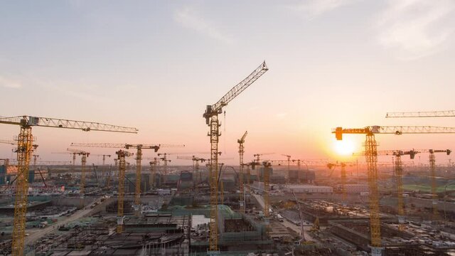 Aerial Flight Over a New Constructions Development Site with High Tower Cranes Building Real Estate. Heavy Machinery and Construction Workers are Employed. Xiongan new area of Beijing china.