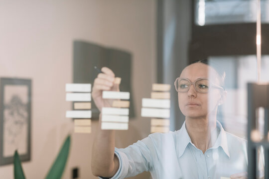 Smiling Woman Creating A Plan in Coworking Space