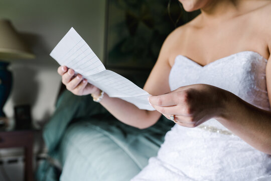 bride reading letter before wedding