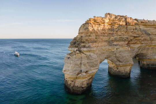 limestone cliffs forming natural arch at Algarve coast, Portugal