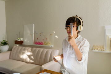 Pre-teen Boy measuring a perspective using a scale ruler